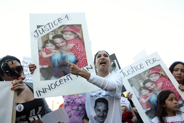 Gigi Fahmi shouts at L.A. County Deputy Sheriffs outside the Compton sheriff’s station during a demonstration over the fatal, deputy-involved shooting of Jose de la Trinidad. He was unarmed and one witness says he was complying with the deputies’ orders.
