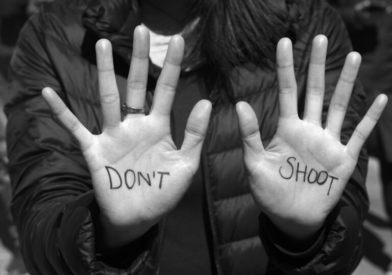 This is a photo of a pair of hands with the words 'don't shoot' written on them, taken at the March for Our Lives March 24, 2018 in Washington, D.C.