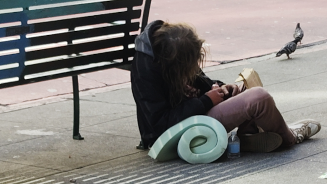 Exhausted man with his bedroll in downtown San Francisco