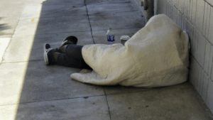 Asleep in downtown San Francisco, his blanket his only shelter