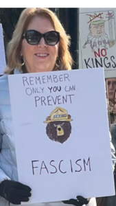 A woman holds a sign at a NO ICE rally and march in Sacramento CA. Photo/Cathleen Williams