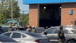 Border Patrol agents at car shop 35th and California, Chicago