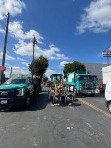 Sweeps underway in LA - dump trucks and bulldozers ready. Photo/Cathleen Williams